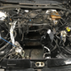 Blyth’s empty engine bay, featuring the newly silver heat-wrapped aircon lines to the left of the big hole.